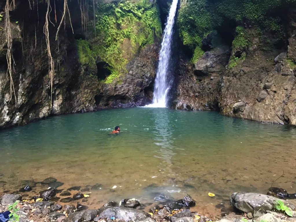 Hiker bathing in waterfall